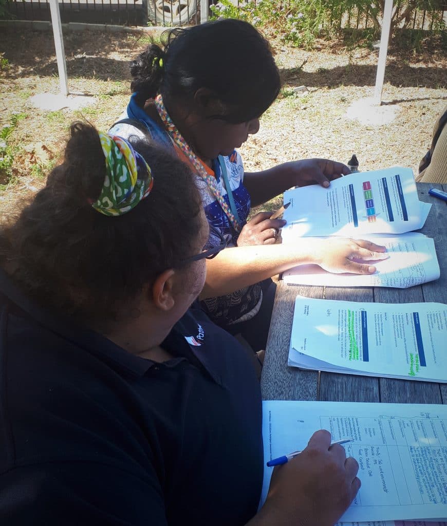 My Pathway mentor Leah Garling assists support worker Gaylene at an outdoor table