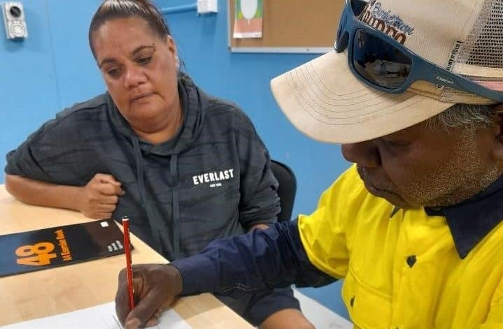Lyric Douglas, an Indigenous participant in Gamburija Gannga, the LLND project in Doomadgee completes a workbook to build foundation skills.
