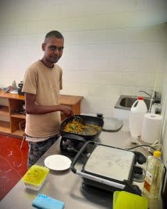 Waylon cooks in our Disability Supports hub to develop his independence